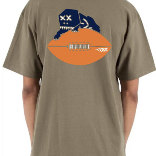 Khaki colored heavyweight streetwear t-shirt featuring bold three-color screenprint on the back—Boxhead Bear design with navy and white embroidered face perched on an orange football. Original Chicago Bears logo adaptation.