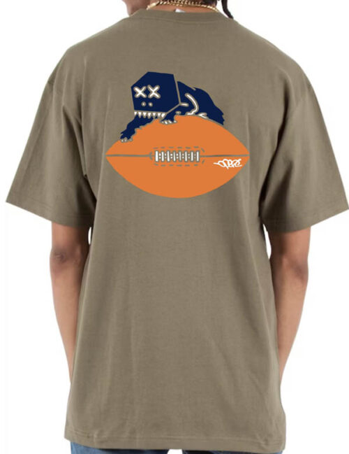 Khaki colored heavyweight streetwear t-shirt featuring bold three-color screenprint on the back—Boxhead Bear design with navy and white embroidered face perched on an orange football. Original Chicago Bears logo adaptation.