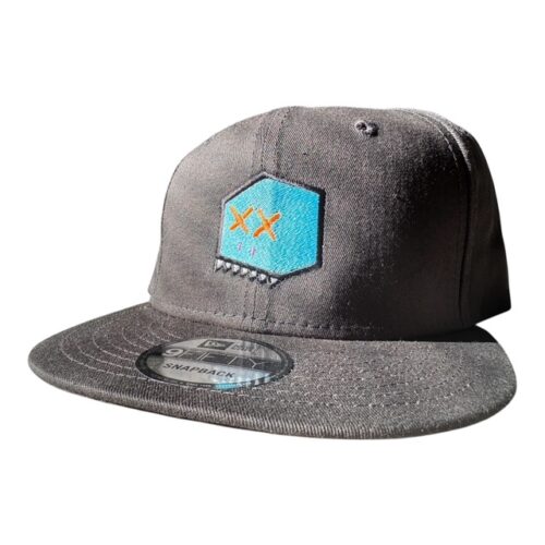 Black snapback hat with turquoise patch featuring embroidered ‘XX’ eyes and pink mouth detail, BXHD Boxhead design.